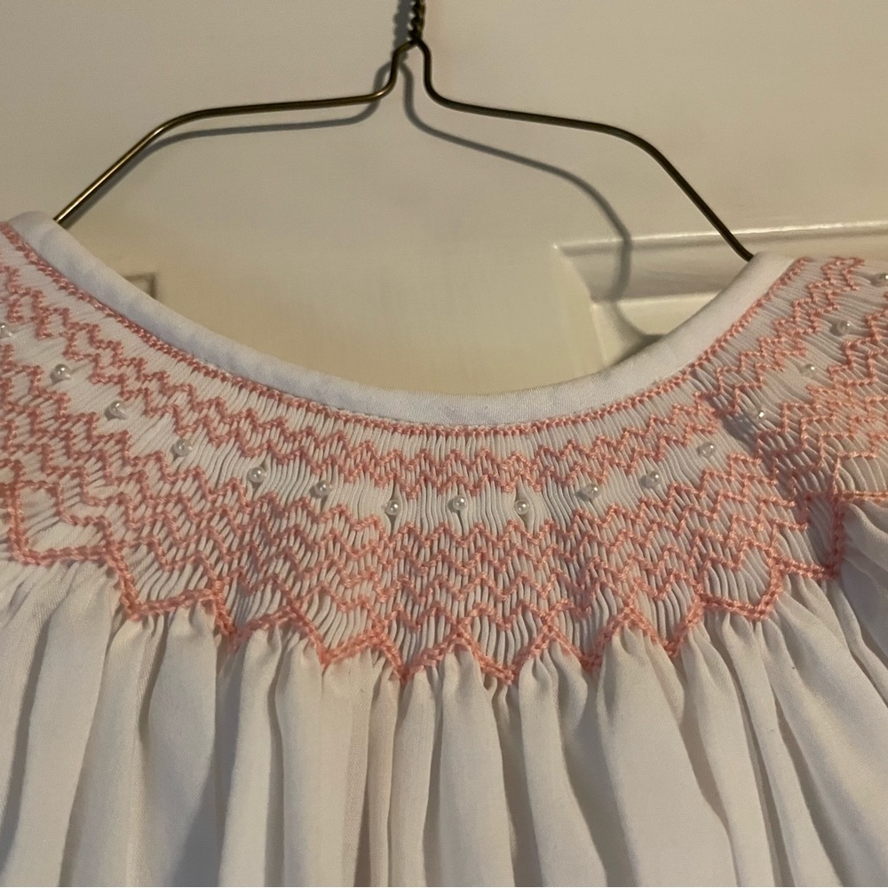 White dress with pink smocking